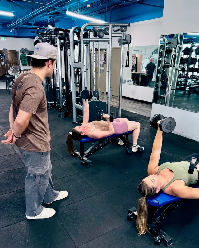Real coaching, real clients — Boston Adams, NASM-CPT Boston Adams coaching two clients through dumbbell bench press at Ally Fitness