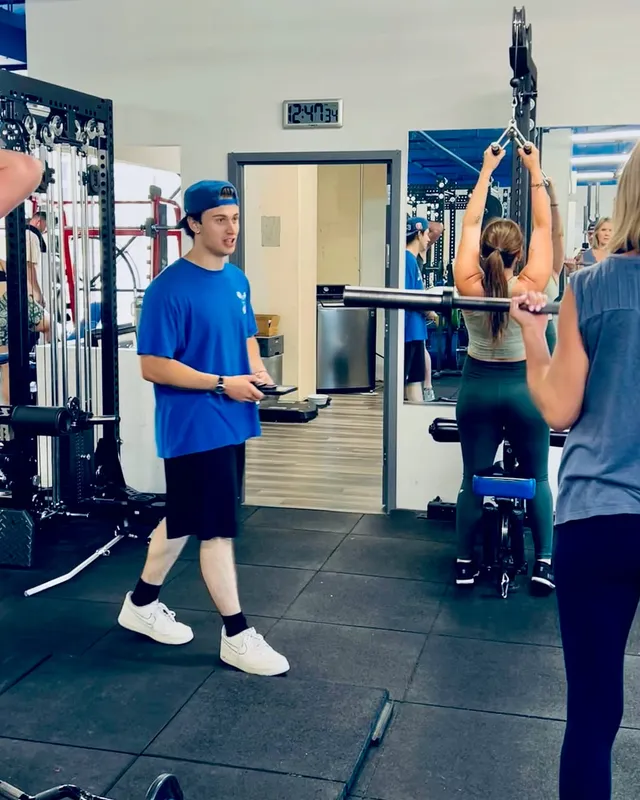 Boston Adams coaching a small group through a barbell strength session